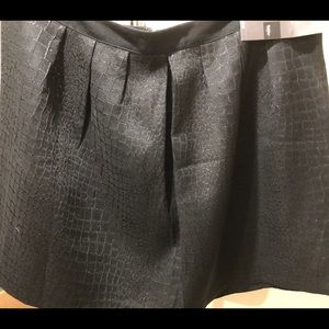 A line skirt with box pleats.